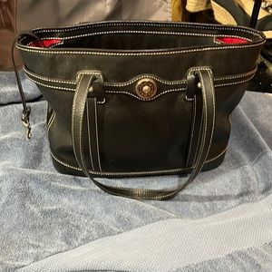 Dooney & Bourke black purse with red lining! VERY NICE BAG! Lots of room!